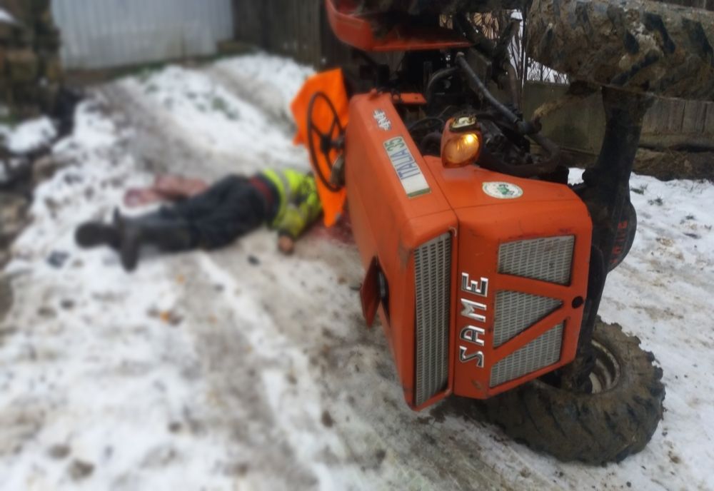 FOTO: Accident cumplit într-un sat din Bistrița-Năsăud, pe un drum de țară! Un bărbat a fost găsit mort, prins sub un tractor