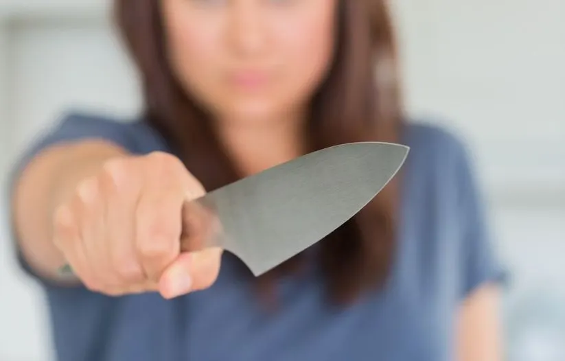 Woman holding knife out
